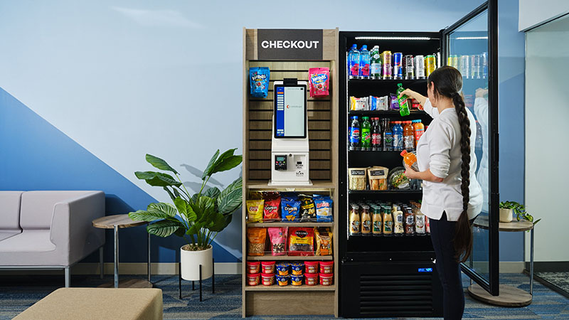 A young woman at work checking out on her Micro Market. - ProCity Vending in Houston, Tx.
